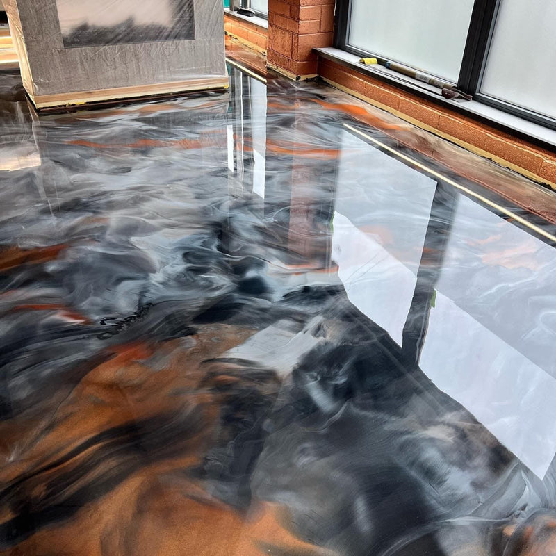 Epoxy floor with a marble-like pattern in a room with furniture.